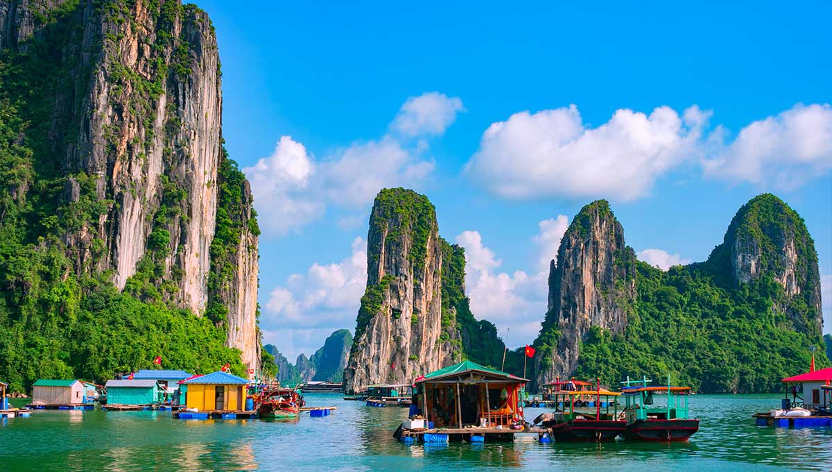 Floating fishing village and rock island in Halong Bay Vietnam